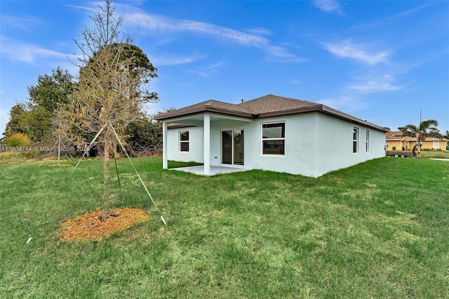 1130 SW Jericho Ave, Port St Lucie, FL 34953 - rear view of property with a lawn, stucco siding, and a patio
