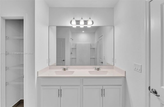 1130 SW Jericho Ave, Port St Lucie, FL 34953 - bathroom featuring double vanity, a walk in closet, and a shower
