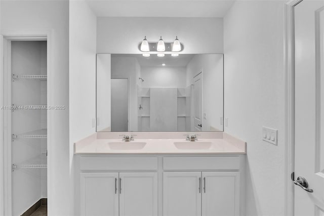 1130 SW Jericho Ave, Port St Lucie, FL 34953 - full bath featuring double vanity, a walk in closet, and a shower