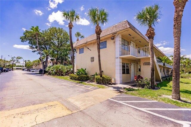 5156 NE 6th Ave Unit 227, Oakland Park, FL 33334 - view of building exterior featuring uncovered parking