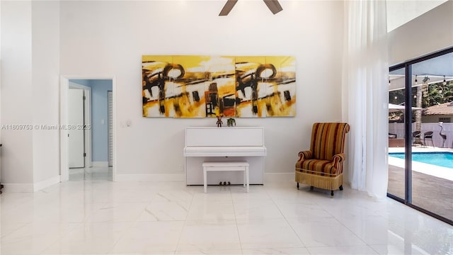 10412 NW 6th St, Coral Springs, FL 33071 - sitting room featuring marble finish floors, a high ceiling, ceiling fan, and baseboards