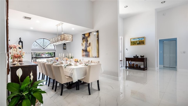 10412 NW 6th St, Coral Springs, FL 33071 - dining space with marble finish flooring, a towering ceiling, recessed lighting, and baseboards