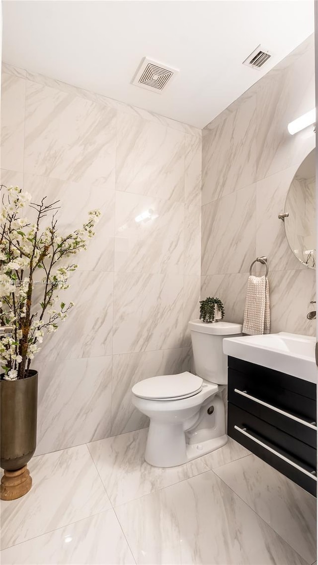 10412 NW 6th St, Coral Springs, FL 33071 - half bath with tile walls, vanity, toilet, and marble finish flooring