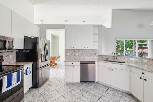 5708 NW 47th Ct, Coral Springs, FL 33067 - kitchen with appliances with stainless steel finishes, a sink, tasteful backsplash, open shelves, and a textured ceiling