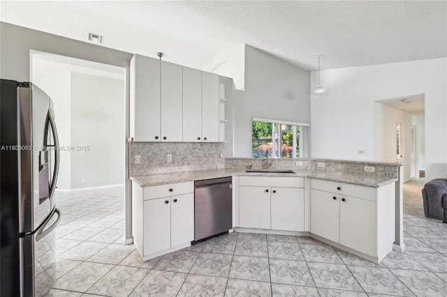 5708 NW 47th Ct, Coral Springs, FL 33067 - kitchen with stainless steel appliances, a sink, open shelves, a peninsula, and white cabinets