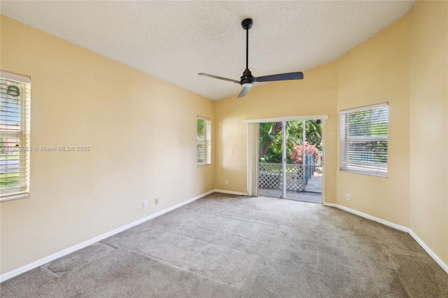 5708 NW 47th Ct, Coral Springs, FL 33067 - carpeted empty room with plenty of natural light, a ceiling fan, baseboards, vaulted ceiling, and a textured ceiling