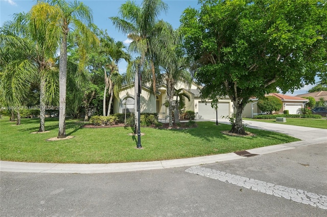 5708 NW 47th Ct, Coral Springs, FL 33067 - view of front of property featuring driveway, a front yard, stucco siding, and an attached garage