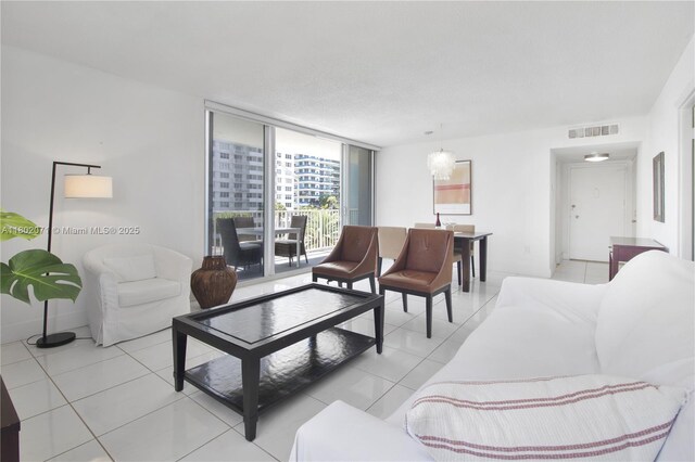 5838 Collins Ave Unit 2H, Miami Beach, FL 33140 - living area featuring light tile patterned floors and expansive windows