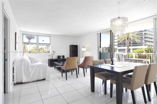 5838 Collins Ave Unit 2H, Miami Beach, FL 33140 - dining room featuring a chandelier, a textured ceiling, and light tile patterned floors