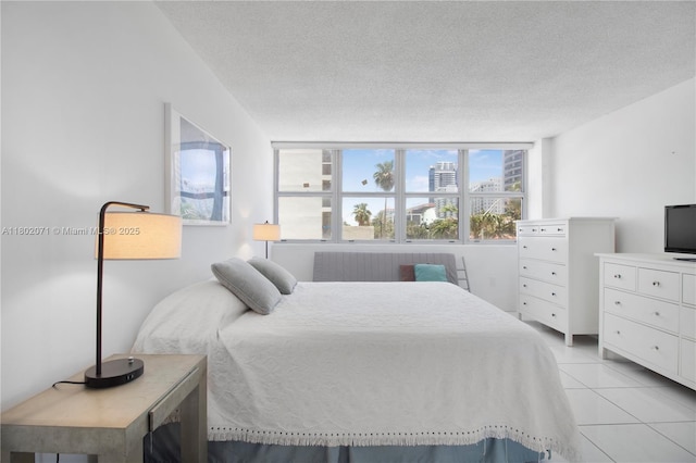 5838 Collins Ave Unit 2H, Miami Beach, FL 33140 - bedroom featuring a textured ceiling and light tile patterned floors