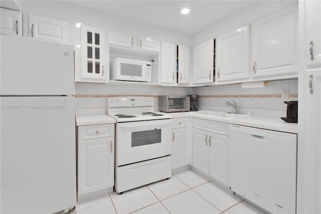 5838 Collins Ave Unit 2H, Miami Beach, FL 33140 - kitchen featuring white appliances, light tile patterned floors, white cabinetry, light countertops, and recessed lighting