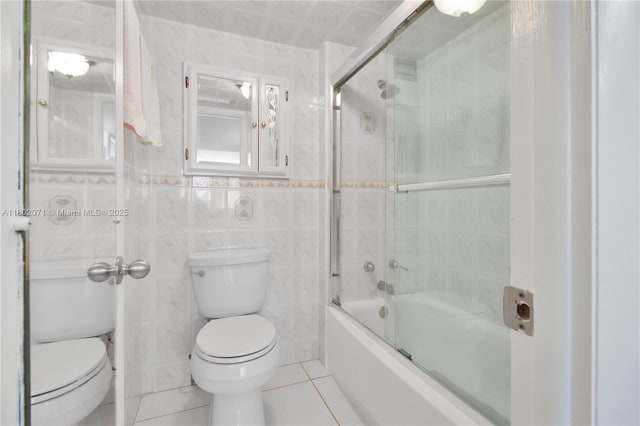 5838 Collins Ave Unit 2H, Miami Beach, FL 33140 - bathroom with tile patterned flooring, tile walls, and shower / bath combination with glass door