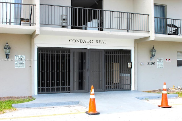 5100 SW 41st St Unit 214, Pembroke Park, FL 33023 - doorway to property featuring stucco siding and an attached garage