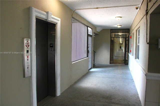 5100 SW 41st St Unit 214, Pembroke Park, FL 33023 - hall featuring elevator and a textured ceiling