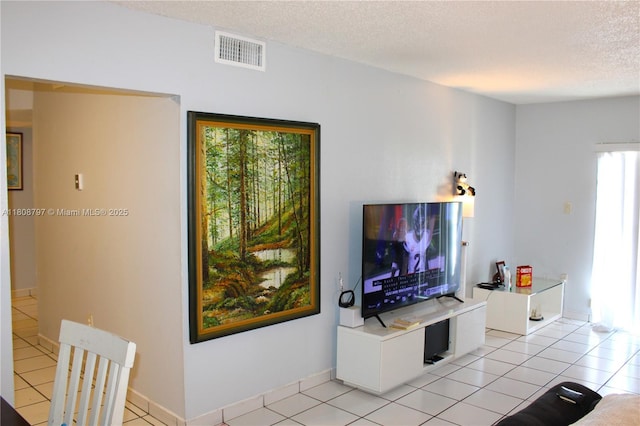 5100 SW 41st St Unit 214, Pembroke Park, FL 33023 - living room featuring a textured ceiling, light tile patterned floors, and baseboards
