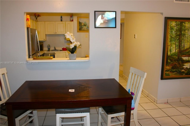 5100 SW 41st St Unit 214, Pembroke Park, FL 33023 - dining room with light tile patterned floors and baseboards