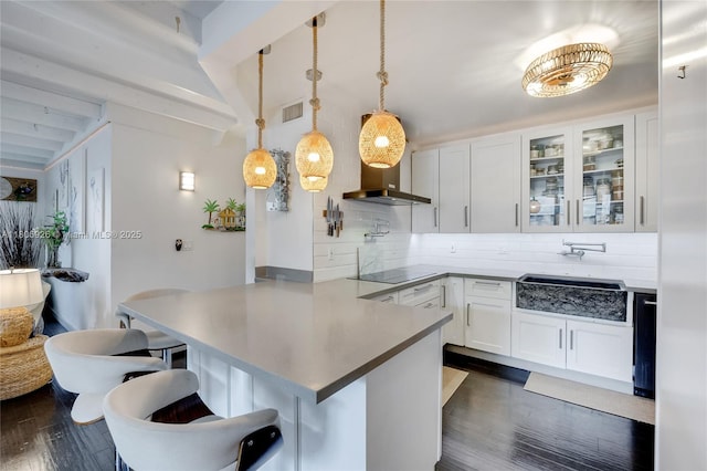 1601 S Ocean Dr Unit 106, Hollywood, FL 33019 - kitchen with backsplash, a peninsula, a kitchen breakfast bar, white cabinetry, and glass insert cabinets