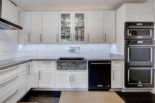 1601 S Ocean Dr Unit 106, Hollywood, FL 33019 - kitchen with black appliances, extractor fan, white cabinets, and a sink