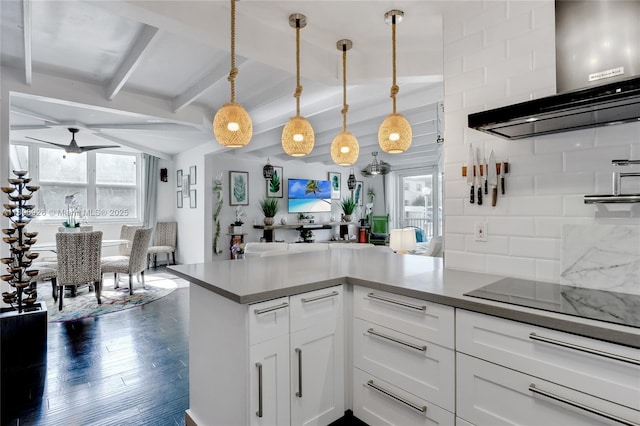 1601 S Ocean Dr Unit 106, Hollywood, FL 33019 - kitchen featuring wall chimney range hood, open floor plan, hanging light fixtures, tasteful backsplash, and white cabinets