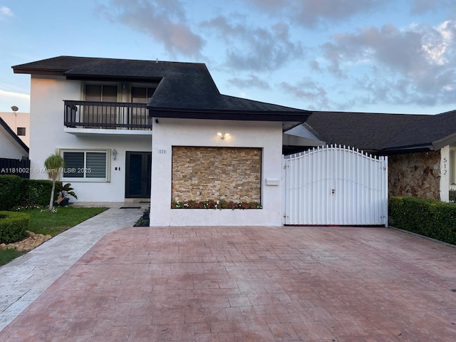 520 SW 90th Ct, Miami, FL 33174 - view of front of property with stucco siding, a gate, a balcony, and a garage