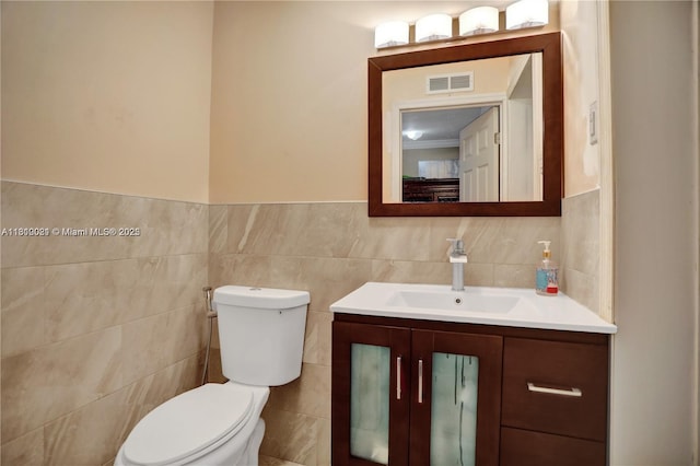 520 SW 90th Ct, Miami, FL 33174 - half bath with tile walls, toilet, vanity, and a wainscoted wall