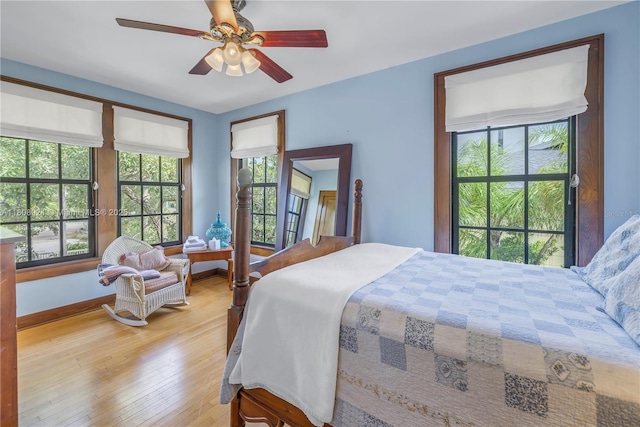 515 Gulf Blvd, Indian Rocks Beach, FL 33785 - bedroom featuring multiple windows, light wood finished floors, ceiling fan, and baseboards