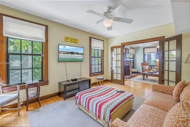 515 Gulf Blvd, Indian Rocks Beach, FL 33785 - living room with wood finished floors, ceiling fan, baseboards, and french doors