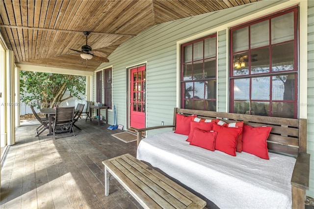 515 Gulf Blvd, Indian Rocks Beach, FL 33785 - covered porch with a ceiling fan and outdoor dining space