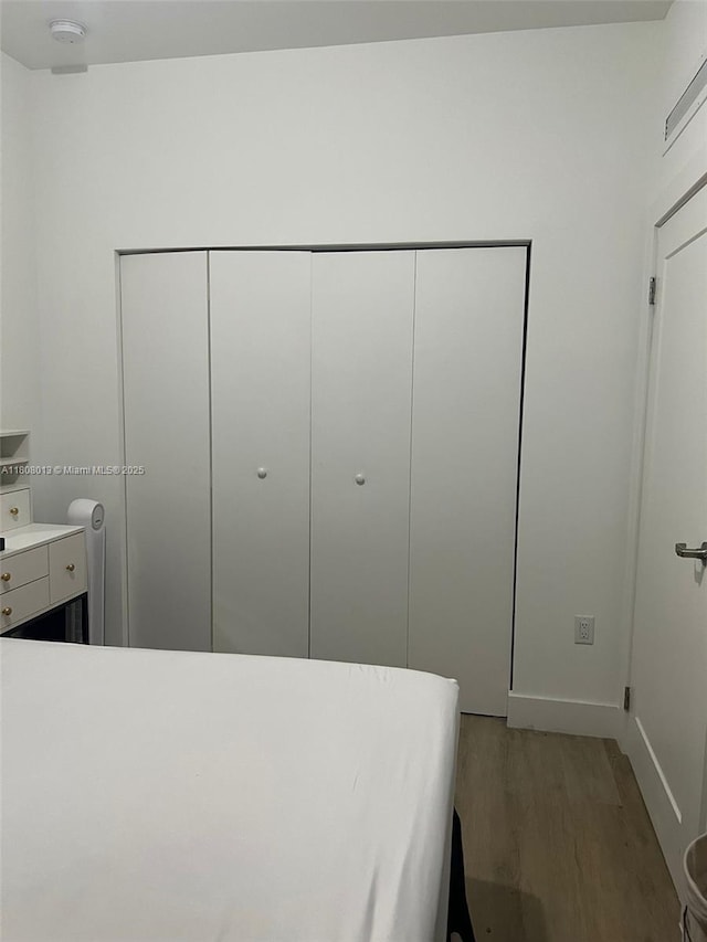 4100 SW 64th Ave Unit 201, Davie, FL 33314 - bedroom with light wood finished floors, a closet, and baseboards