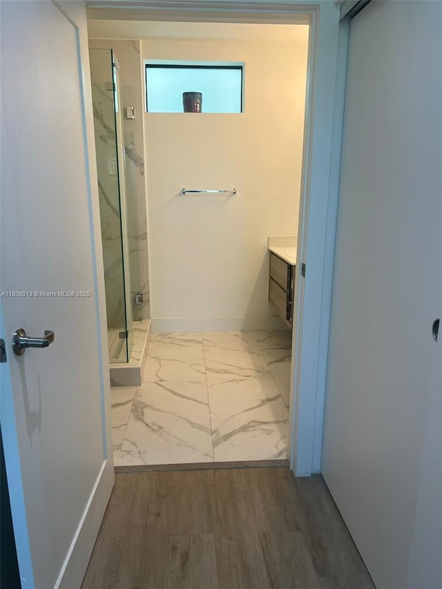 4100 SW 64th Ave Unit 201, Davie, FL 33314 - full bathroom with vanity, a marble finish shower, marble look tile flooring, and baseboards