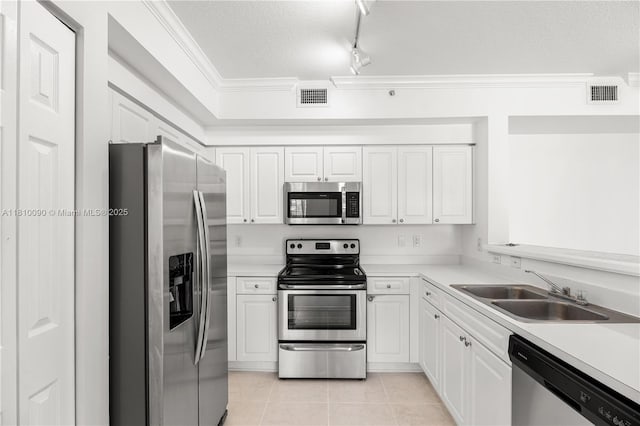 6851 SW 44th St Unit 109, Miami, FL 33155 - kitchen featuring appliances with stainless steel finishes, white cabinetry, light tile patterned floors, light countertops, and crown molding