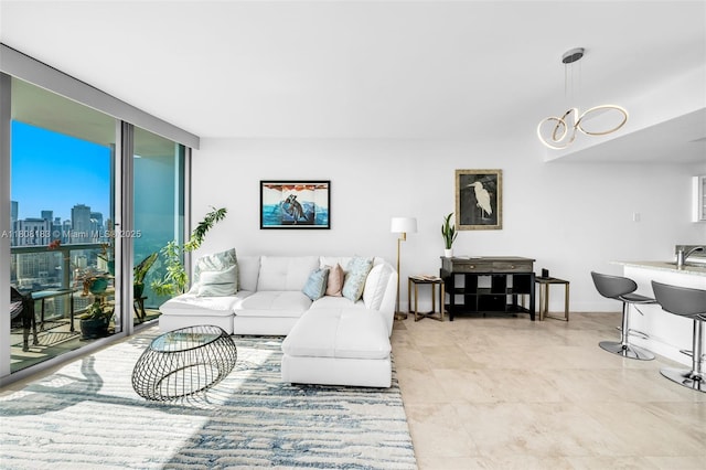 888 Biscayne Blvd Unit 3702, Miami, FL 33132 - living area with light tile patterned floors, baseboards, a skyline view, and expansive windows