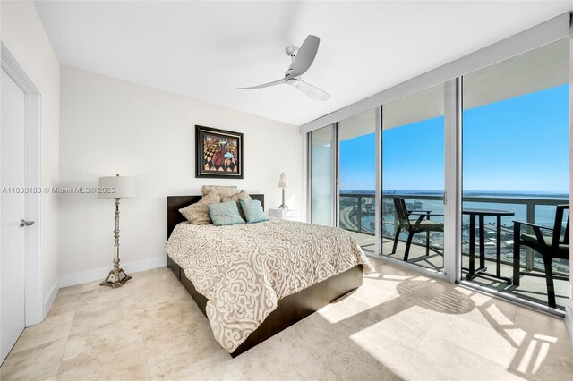 888 Biscayne Blvd Unit 3702, Miami, FL 33132 - bedroom featuring multiple windows, a water view, floor to ceiling windows, ceiling fan, and baseboards