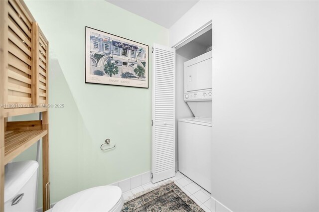 888 Biscayne Blvd Unit 3702, Miami, FL 33132 - bathroom with toilet, stacked washer / drying machine, tile patterned floors, and baseboards