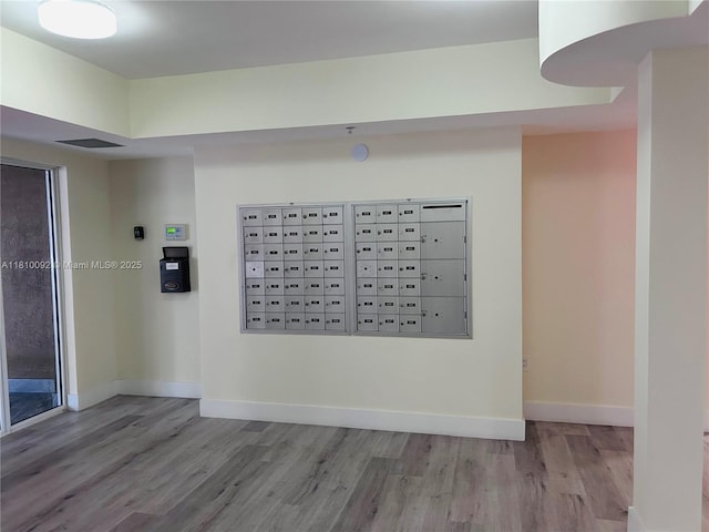 11040 SW 196th St Unit 209, Cutler Bay, FL 33157 - detailed view of mail area, wood finished floors, and baseboards