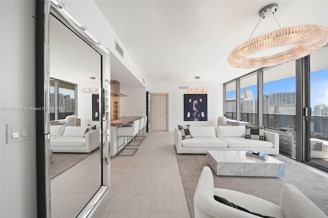 1000 Brickell Plz Unit 4209, Miami, FL 33131 - living room featuring a view of city, a chandelier, and floor to ceiling windows