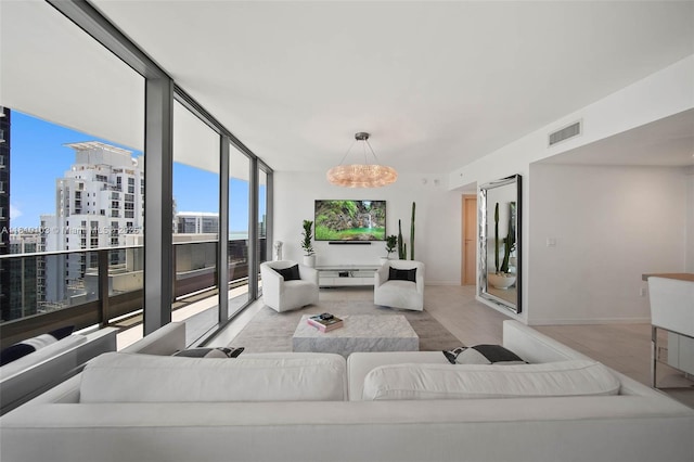 1000 Brickell Plz Unit 4209, Miami, FL 33131 - living room with wood finished floors, a chandelier, a city view, and baseboards