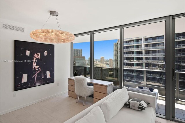 1000 Brickell Plz Unit 4209, Miami, FL 33131 - living area with baseboards, a wall of windows, a view of city, and a chandelier