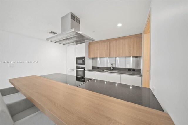 1000 Brickell Plz Unit 4209, Miami, FL 33131 - kitchen featuring black appliances, a sink, extractor fan, modern cabinets, and dark countertops