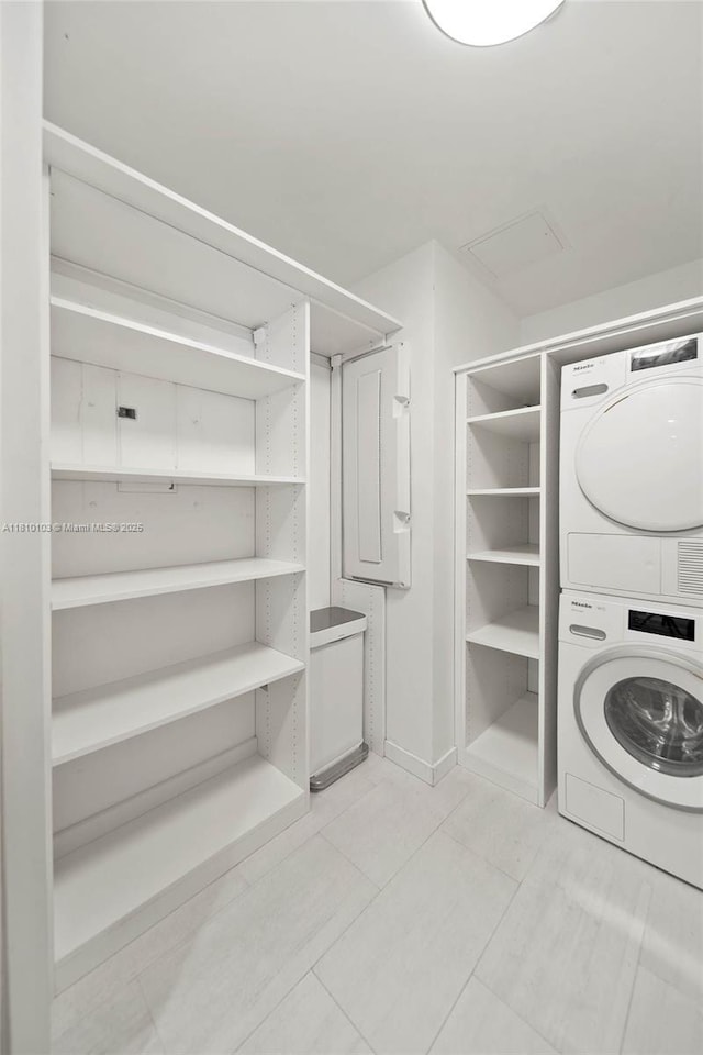 1000 Brickell Plz Unit 4209, Miami, FL 33131 - washroom with stacked washer / drying machine and light tile patterned flooring