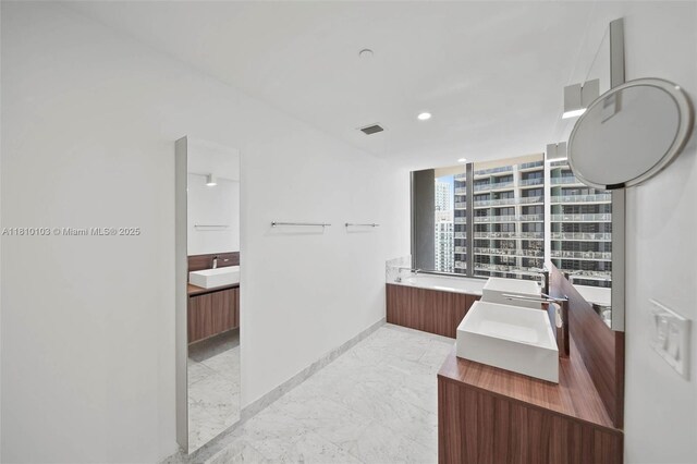 1000 Brickell Plz Unit 4209, Miami, FL 33131 - full bathroom featuring two vanities, marble finish flooring, baseboards, and recessed lighting