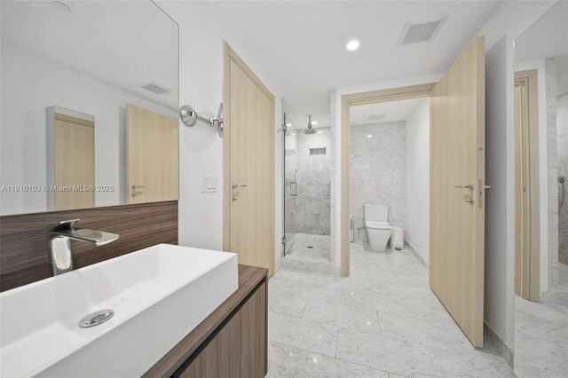 1000 Brickell Plz Unit 4209, Miami, FL 33131 - bathroom featuring a marble finish shower, marble finish flooring, vanity, toilet, and recessed lighting