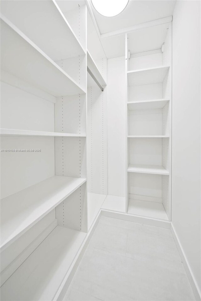 1000 Brickell Plz Unit 4209, Miami, FL 33131 - walk in closet featuring tile patterned floors