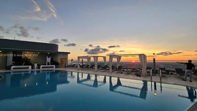 1000 Brickell Plz Unit 4209, Miami, FL 33131 - pool at dusk featuring a patio and a pergola