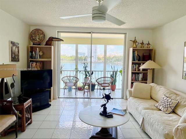 2999 Point E Dr Unit C-409, Aventura, FL 33160 - living room with ceiling fan, light tile patterned floors, and a textured ceiling