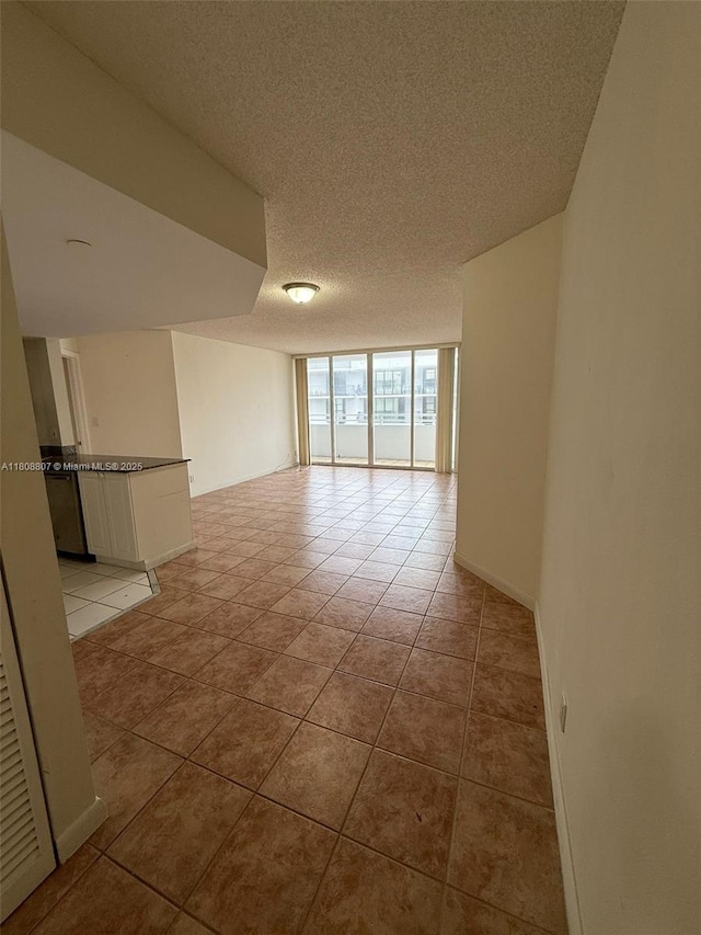 8911 Collins Ave Unit 1103, Surfside, FL 33154 - unfurnished room with a textured ceiling and baseboards