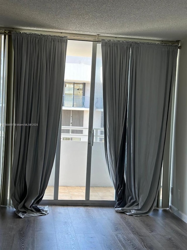 8911 Collins Ave Unit 1103, Surfside, FL 33154 - spare room with wood finished floors and a textured ceiling