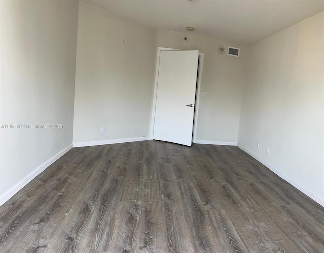 8911 Collins Ave Unit 1103, Surfside, FL 33154 - empty room featuring dark wood-style flooring and baseboards