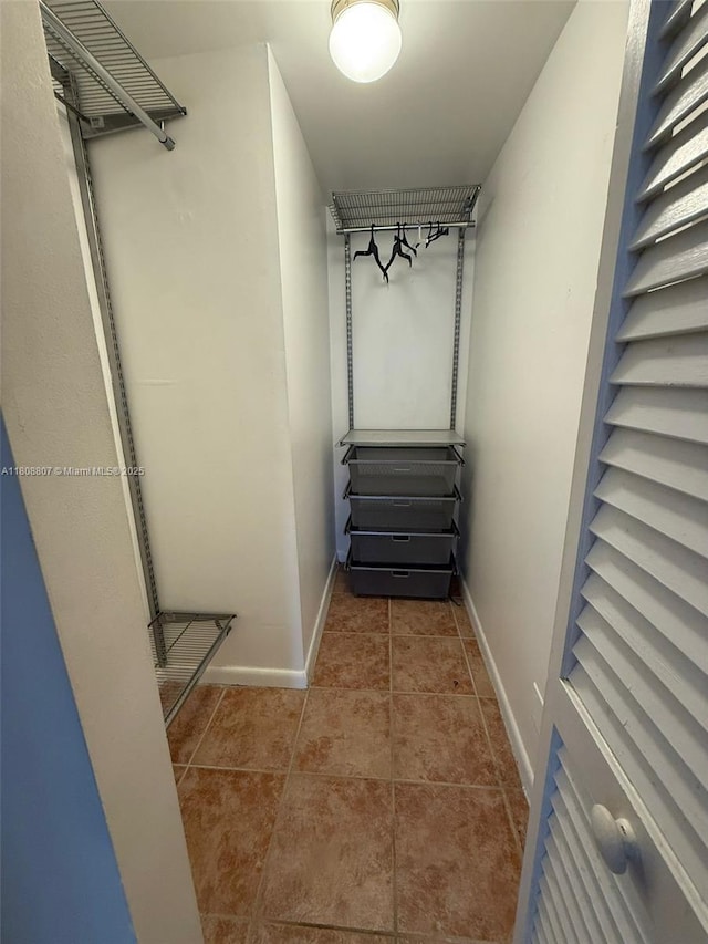 8911 Collins Ave Unit 1103, Surfside, FL 33154 - walk in closet with tile patterned flooring