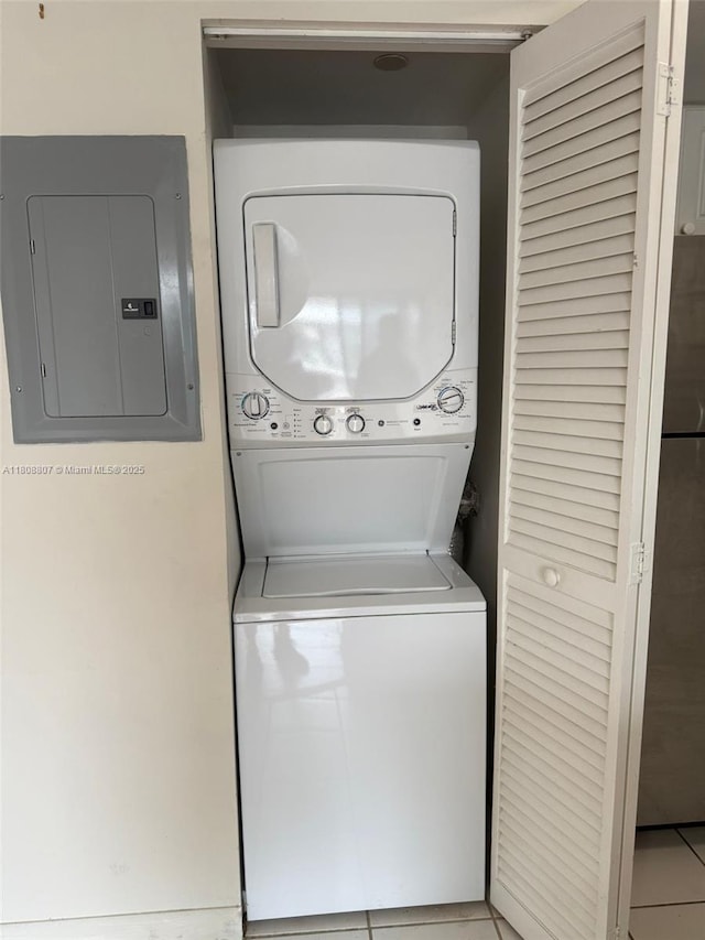 8911 Collins Ave Unit 1103, Surfside, FL 33154 - washroom with stacked washer and clothes dryer, electric panel, and light tile patterned floors